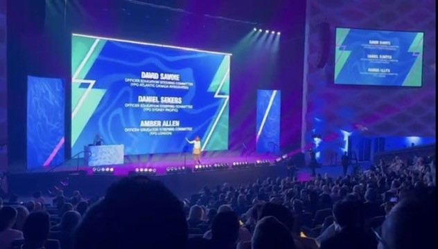Amber Allen speaking to a large audience